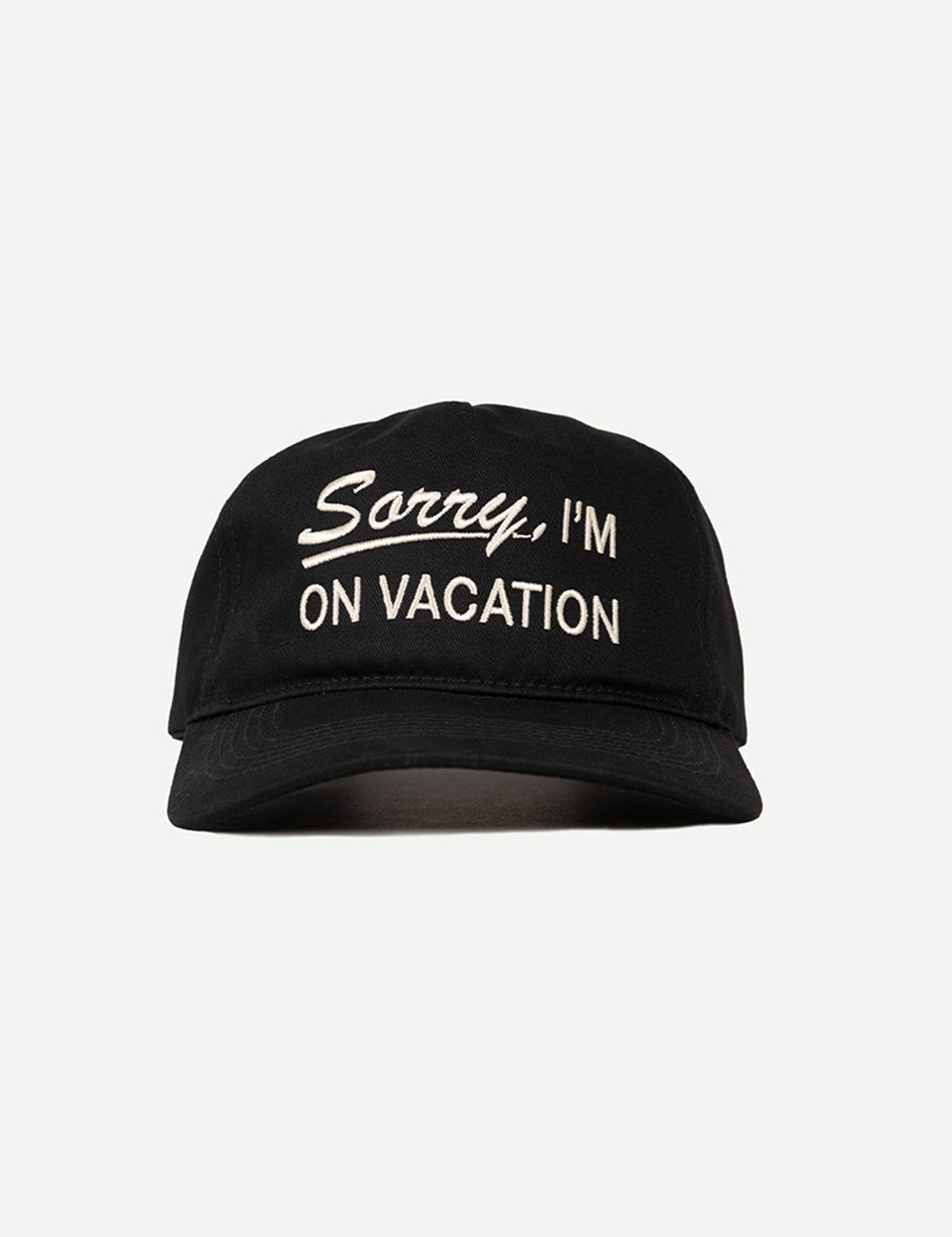 Black cap with 'Sorry, I'm on vacation' text on a light gray background