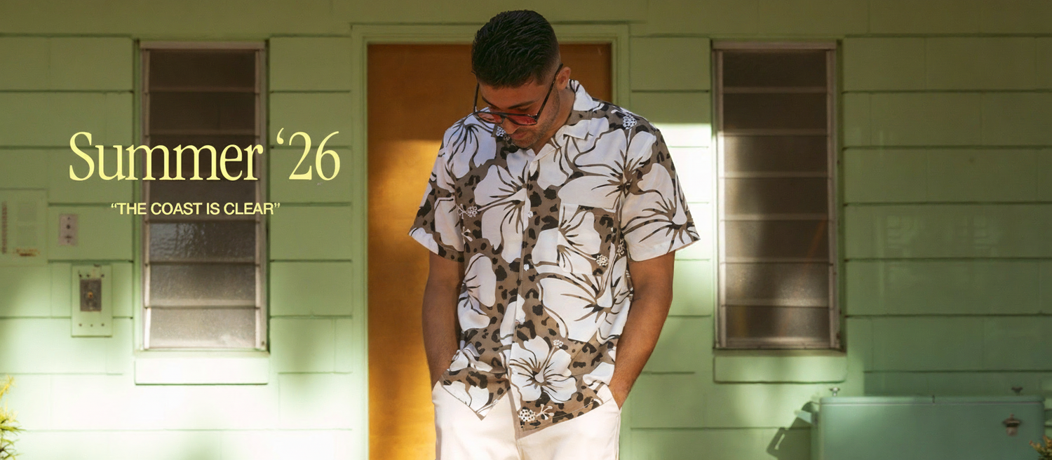 Man wearing a floral shirt and sunglasses standing in front of a green house with 'Summer '26' text.